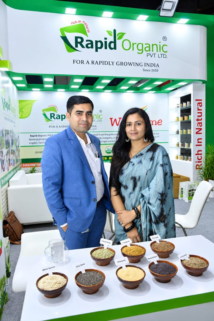 Rapid Organic stall at an expo, with the company's logo board and seed samples
